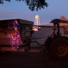 A tractor decorated with Christmas lights.