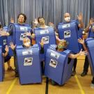 Group of people wearing mailbox costumes.
