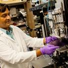 Researcher inserting disk into a machine