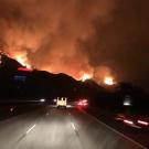 Fire trucks drive toward the Thomas Fire.
