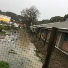 A trench full of water behind the Human Resources Administration Building.
