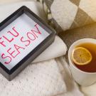 "Flu Season," written at bottom of serving tray, alongside a cup of tea.