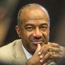 Chancellor Gary S. May, hands clasped at chin level.