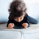 Toddler with phone.