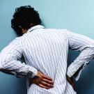 woman clutching back in pain