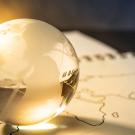 A gold-tinged glass globe on a world map