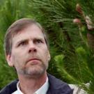 Photo: Tom Gordon looking at a pine tree branch