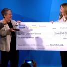 Katie Murphy receives a trophy and giant check.