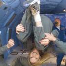 Photo: Students float in various positions in the reduced-gravity chamber.