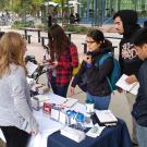 Students gather around a table.