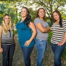 Four women standing in line for their photo