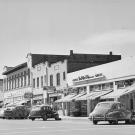 A 1951 photo looking south on G Street in Davis shows shops and vehicles. 