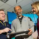 Aggie alumni share a look at a computer screen.