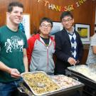 Volunteers serve food during the International House's annual Thanksgiving dinner.