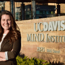 Photo: Jacqueline Barkoski poses at MIND Institute sign.