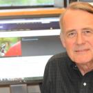 Photo: Professor James Carey in front of a computer monitor