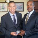 Joe Farrow and Gary S. May hold a police badge.