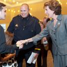 The chancellor shakes hands with Carmichael children.