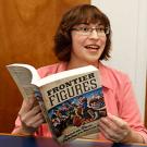 Photo: Musicologist Beth E. Levy, associate professor, holding her book, "Frontier Figures"