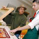 Malaquias Montoya of Chicana/o Studies, works with Pete Benites, a fourth year student, on his print as part of a program that will eventually help teach art to Woodland youth.           