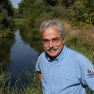 Photo: Peter Moyle foreground, waterway behind.