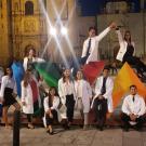 Students in white coats, posing at night in Oaxaca.