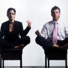 Photo: Employees meditate in chairs at work.