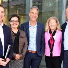 Five people lined up, posed