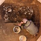 Photo: Person excavating oyster shells with bucket