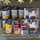 cans of food stacked on a shelf
