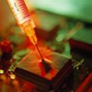 Photo: hypodermic needle piercing square