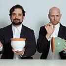 four men in tuxes making music on flower pots