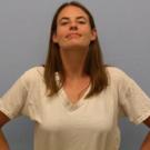 Photo: woman smiling with her hands on her hips and her chest expanded