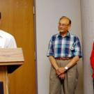 Wing Thye Woo offers comments during the senate meeting as fellow 2004 public service awardees Howard Schutz and Suad Joseph look on.