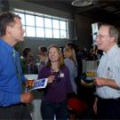 Tom Philp, left, of The Sacramento Bee talks with UC Davis graduate student Sarah Null and faculty adviser Jay Lund, a professor in civil and environmental engineering, during a reception at the Bee honoring Philp for winning  the 2005 Pulitzer 