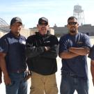 Photo: Campus roofing crew on top of building.
