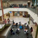 Photo: People at tables in lobby of Student Community Center.
