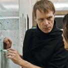 Michael Siminovitch at the white board with a young woman