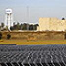 Solar panels with university in the background