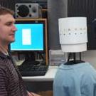 Photo: man staring at cylinder with equipment in background