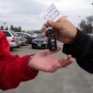 A driver hands off keys to an attendant.