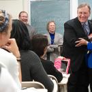 Photo: Dean George R. Mangun embraces the teaching prize recipient, Professor Suad Joseph, in her classroom.