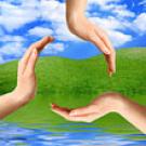 Photo: three hands mimmicking the recycle symbol with wate, sky and grass in the background