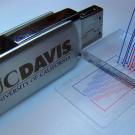 Photo: USB device next to a plastic chip with markings 