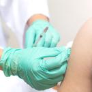 A closeup of a nurse vaccinating a patient