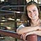 Woman in a livestock pen, posing for the camera