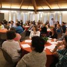 People seated around tables at luncheon.