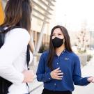 Jena Du on campus talking with a student