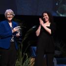 Sue Ebeler with an award next to a presenter