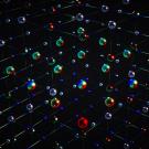 Graphic of colored spheres against a black background. 